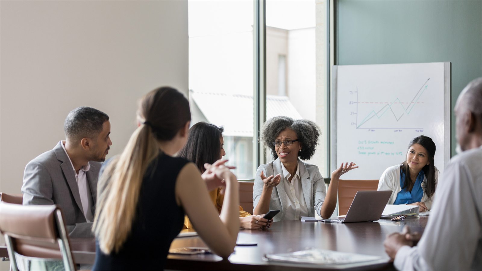 A diverse leadership team discussing strategy around a conference table